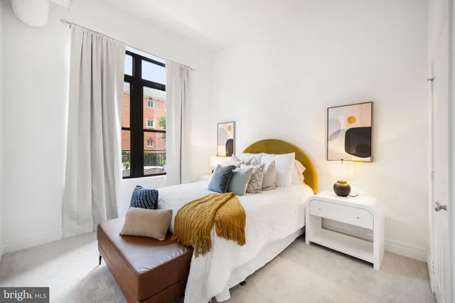 a bedroom with bed and a window