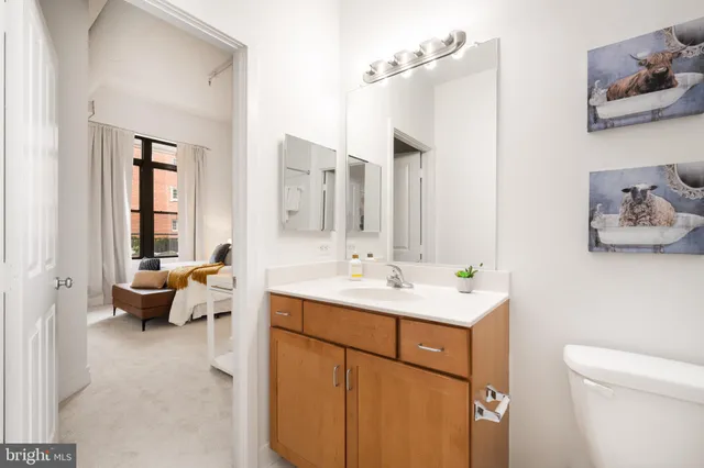 a bathroom with a sink and mirror with toilet