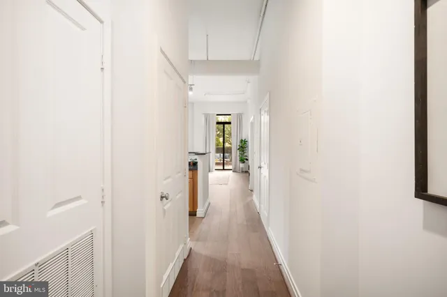 a view of a hallway with wooden floor