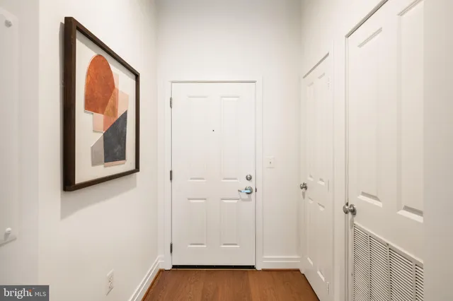 a view of an entryway with wooden floor