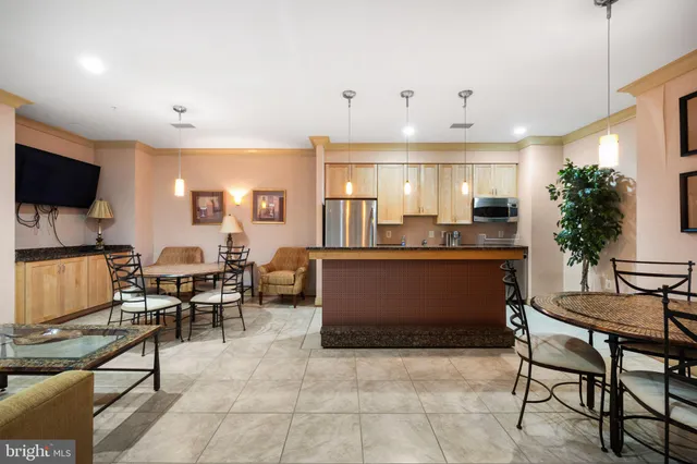 a large kitchen with a table and chairs