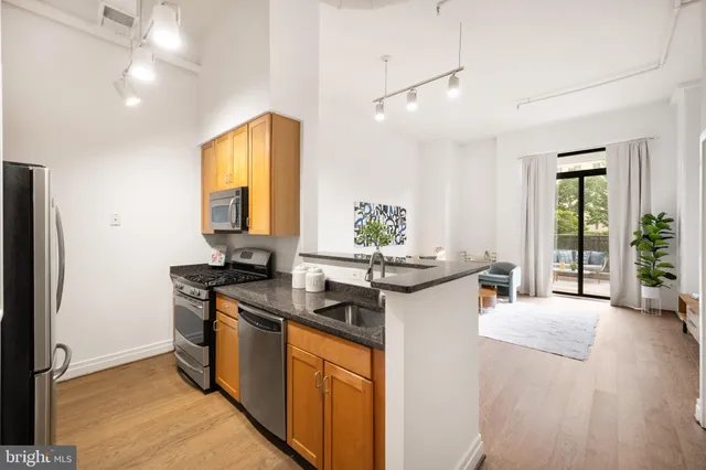 a kitchen with a sink stove and refrigerator