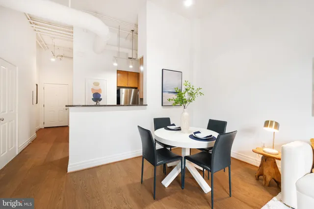 a view of a dining room with furniture and wooden floor