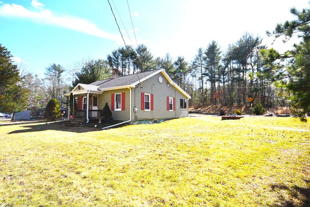 273 Snipatuit Road Rochester, MA 02770 - Photo 2 of 7 a front view of house with yard and trees in the background