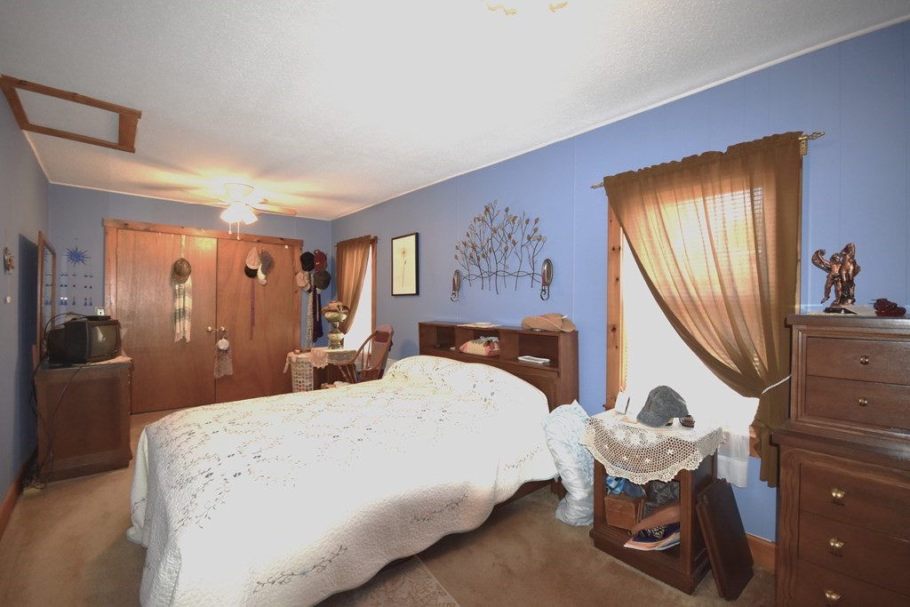 273 Snipatuit Road Rochester, MA 02770 - Photo 7 of 7 a bedroom with a bed and wooden floor