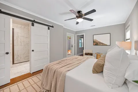 a bedroom with a large bed and a chandelier