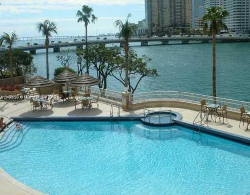 701 Brickell Key Boulevard, Unit 2412 Miami, FL 33131 - Photo 6 of 10 a view of a lake with couches and wooden floor