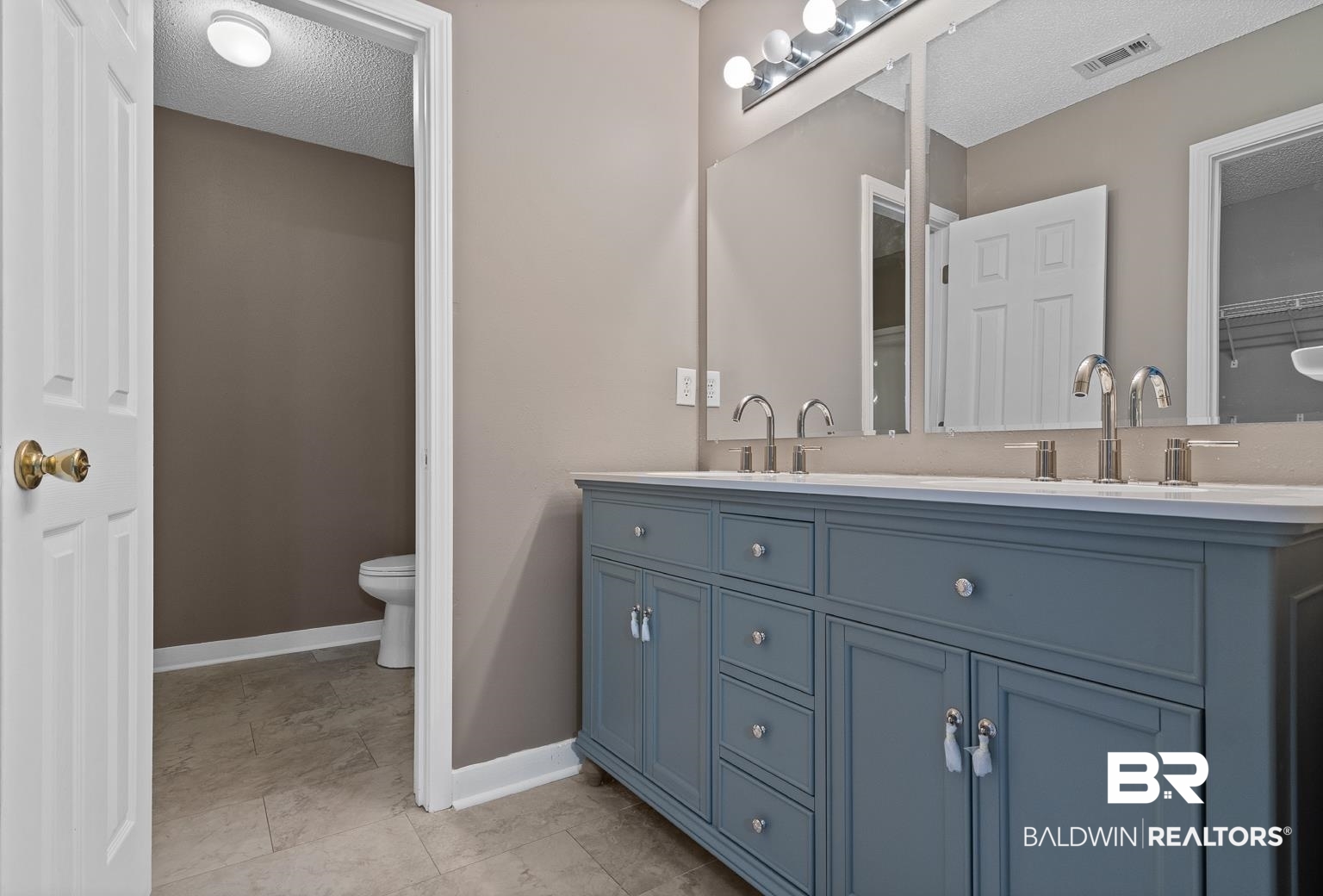 16418 Avent Lane Foley, AL 36535 - Photo 24 of 30 Bathroom with a textured ceiling, vanity, and toilet