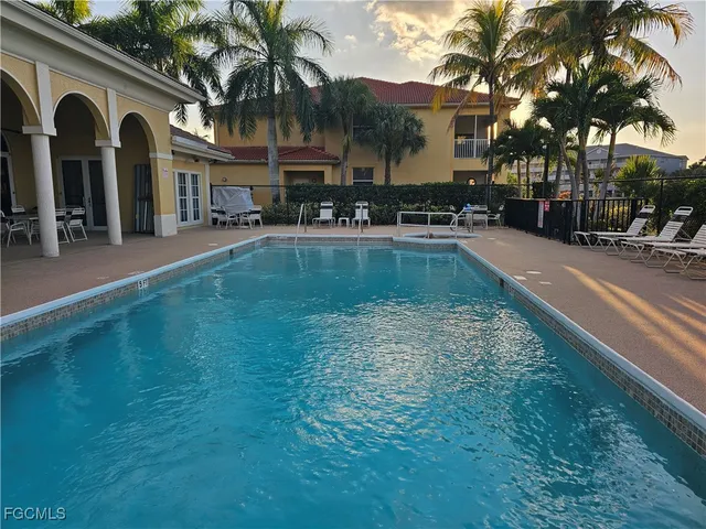 a swimming pool with outdoor seating and yard
