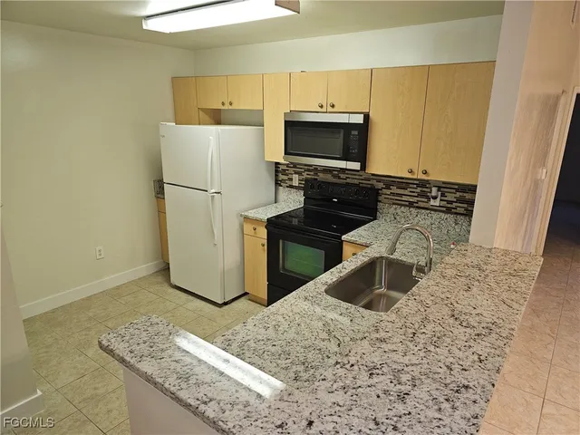 a kitchen with a sink stove and refrigerator