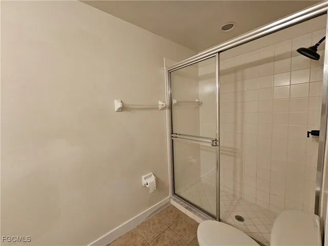 a bathroom with a shower and a toilet
