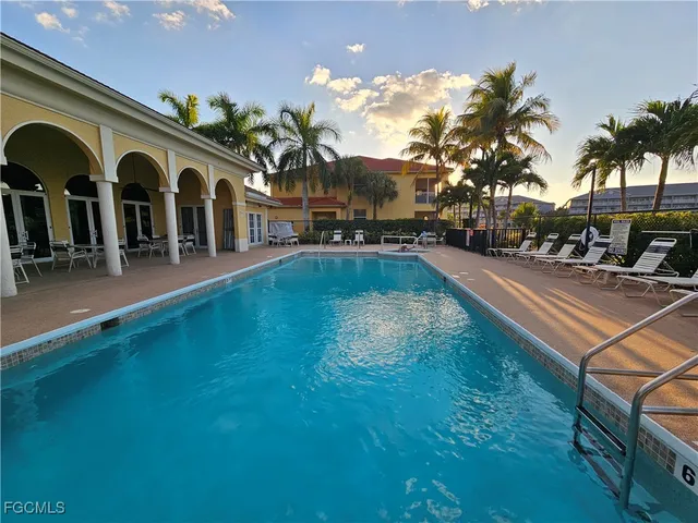 a view of a swimming pool with an outdoor seating