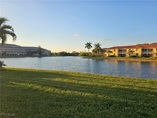 a view of a lake with houses in the background
