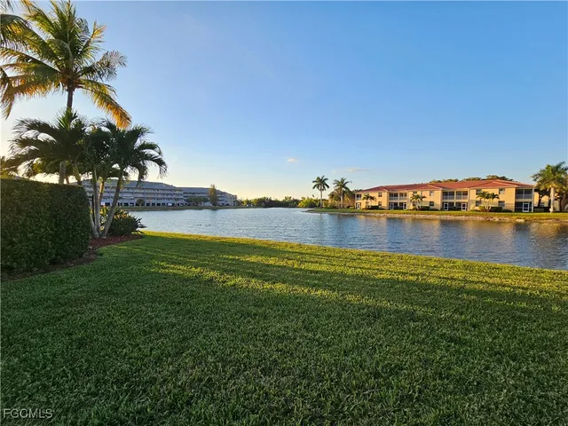 a view of a lake with houses in the back