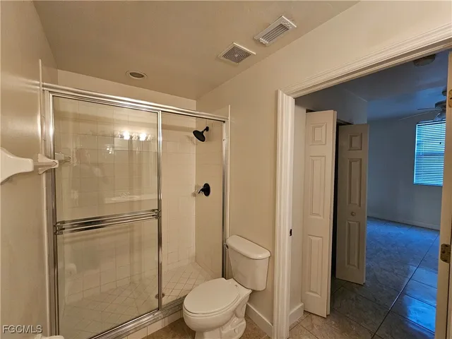 a bathroom with a glass shower door