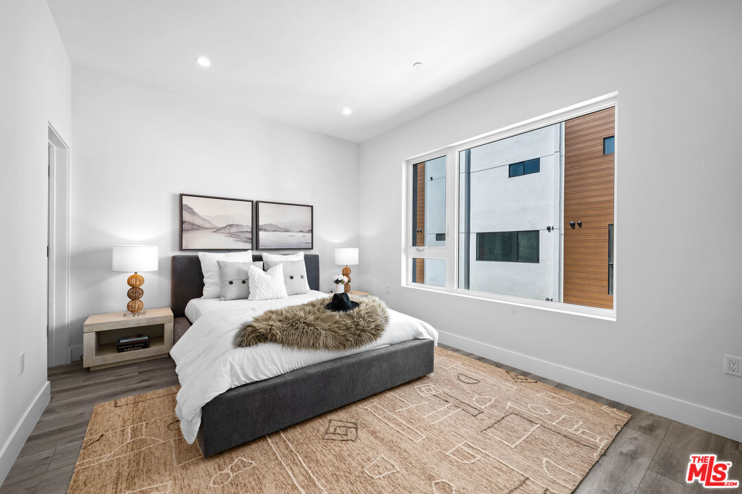 1959 Preuss Road Los Angeles, CA 90034 - Photo 11 of 29 a bedroom with a large bed and a window