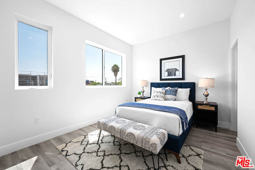 1959 Preuss Road Los Angeles, CA 90034 - Photo 17 of 29 a bedroom with a bed and a painting on the wall