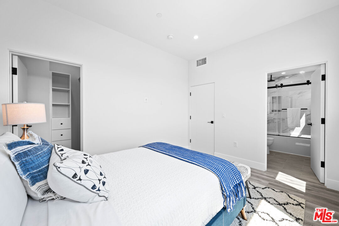 1959 Preuss Road Los Angeles, CA 90034 - Photo 18 of 29 a bedroom with a large bed and a dresser