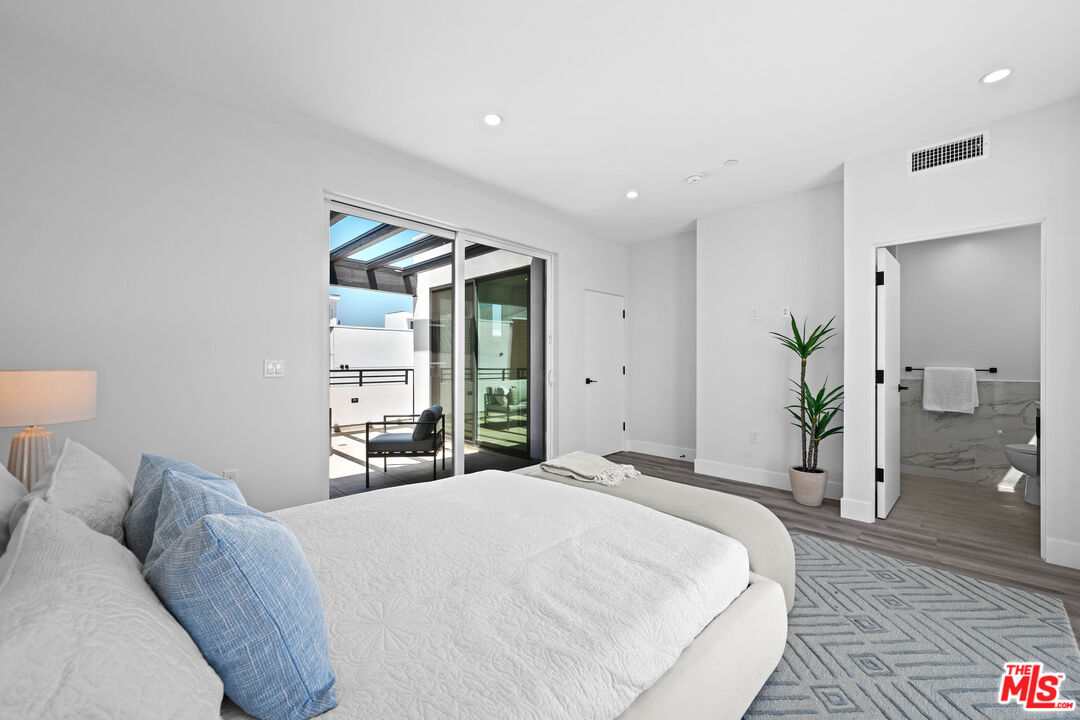 1959 Preuss Road Los Angeles, CA 90034 - Photo 21 of 29 a bedroom with a large bed and a large window