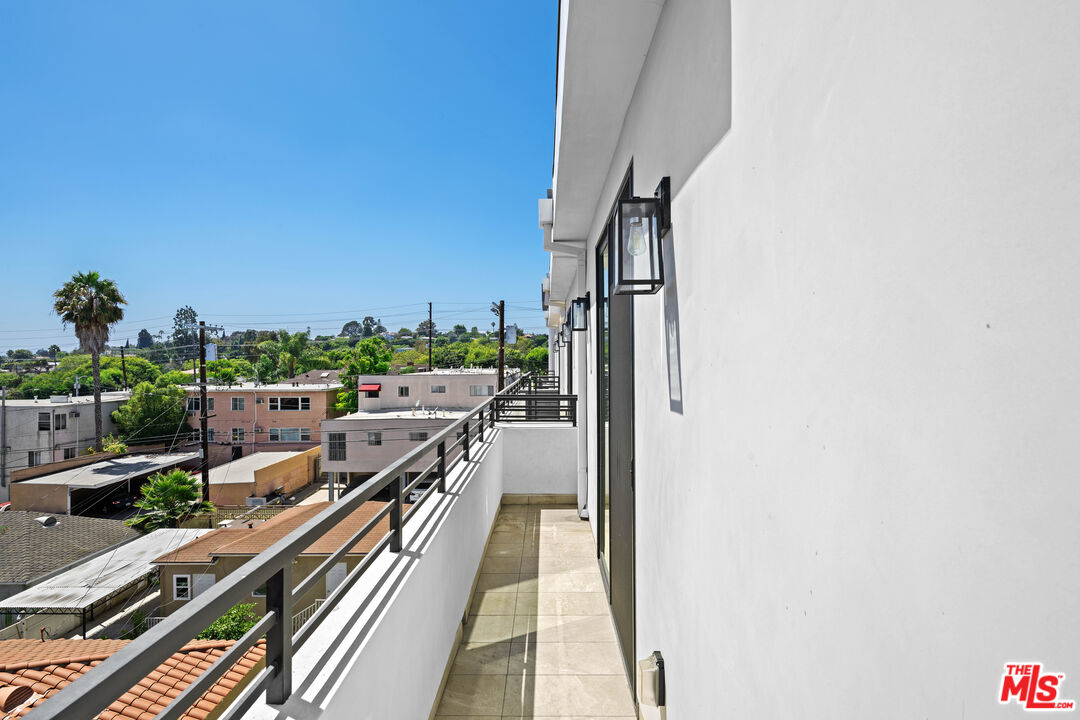 1959 Preuss Road Los Angeles, CA 90034 - Photo 23 of 29 a view of a balcony with wooden floor and city view