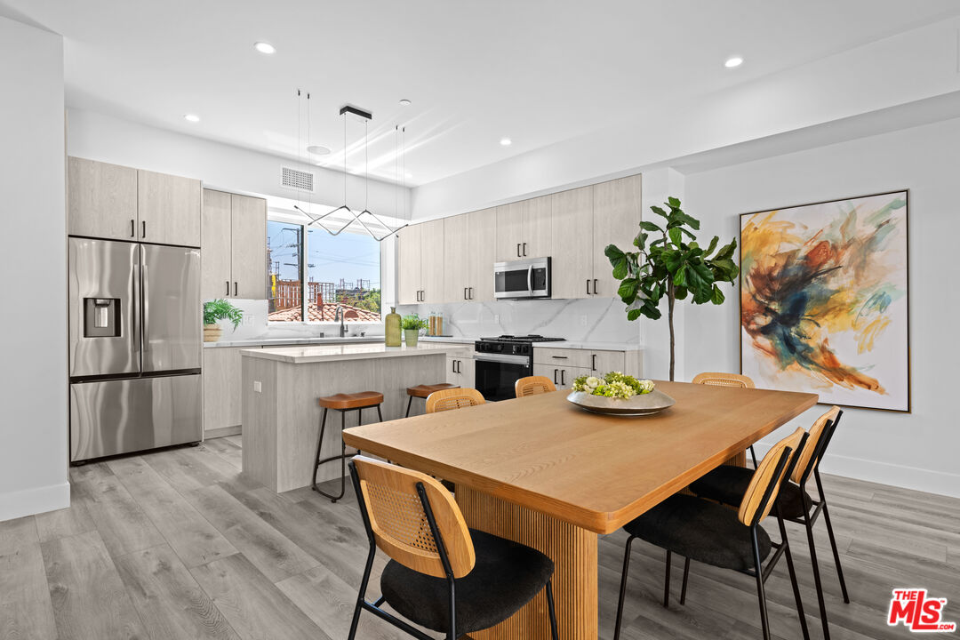 1959 Preuss Road Los Angeles, CA 90034 - Photo 5 of 29 a kitchen with stainless steel appliances granite countertop a dining table and chairs
