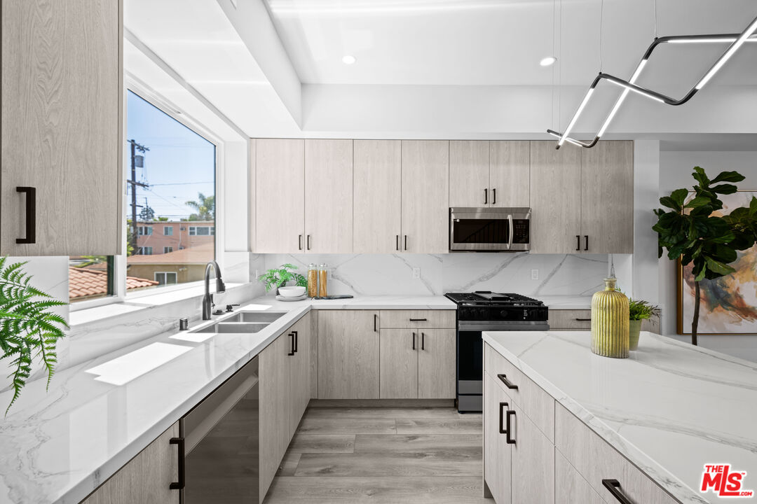 1959 Preuss Road Los Angeles, CA 90034 - Photo 7 of 29 a kitchen with a sink a stove and cabinets