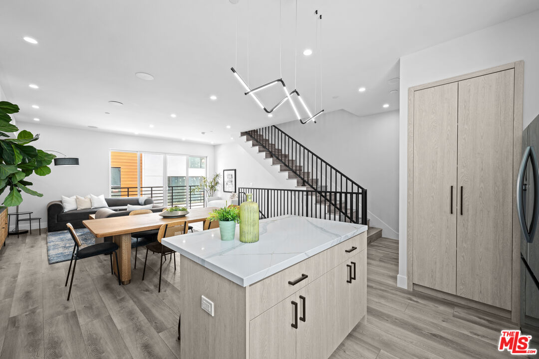 1959 Preuss Road Los Angeles, CA 90034 - Photo 8 of 29 a living room with stainless steel appliances kitchen island a table and chairs in it