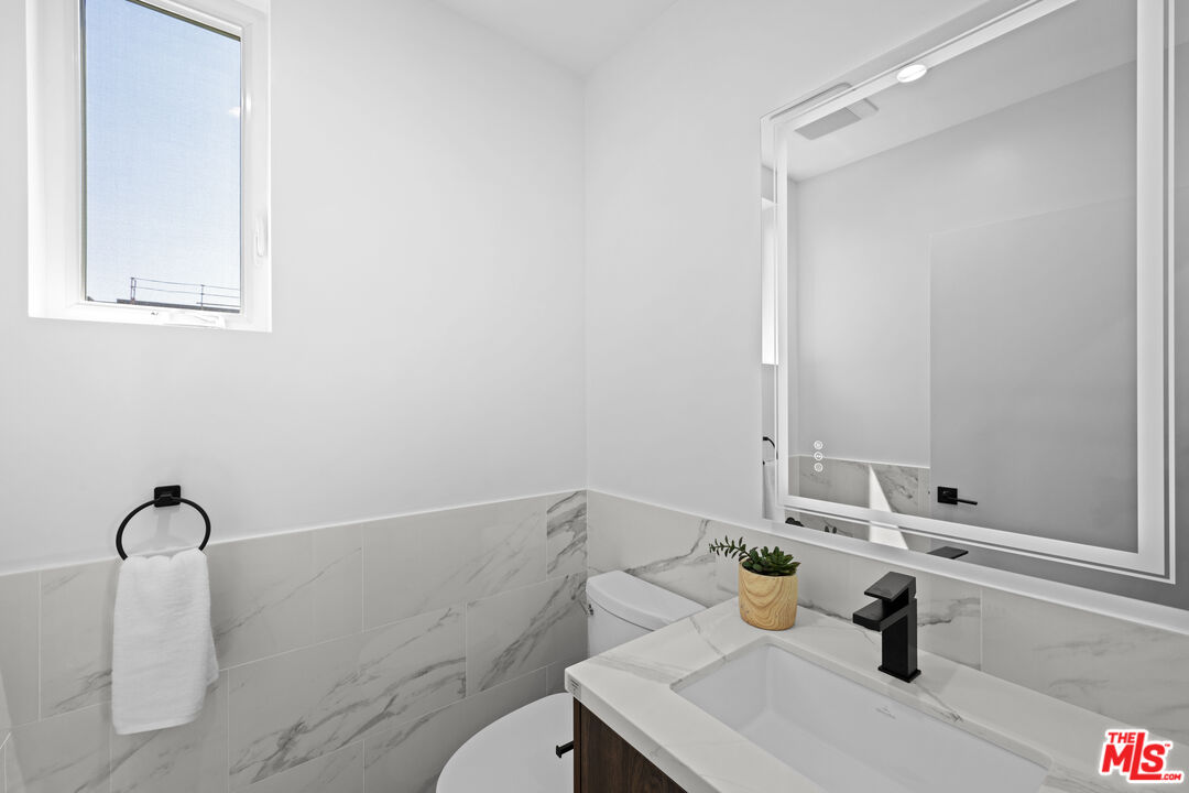 1959 Preuss Road Los Angeles, CA 90034 - Photo 9 of 29 a bathroom with a sink and a mirror