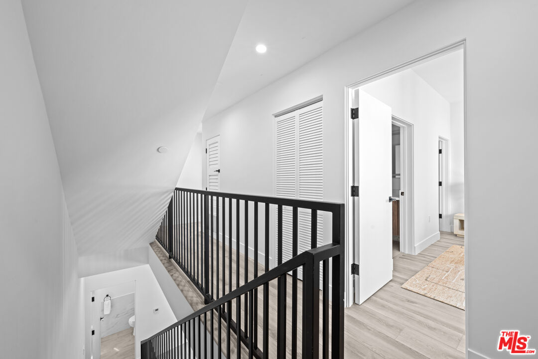 1959 Preuss Road Los Angeles, CA 90034 - Photo 10 of 29 a view of a hallway with wooden floor and staircase