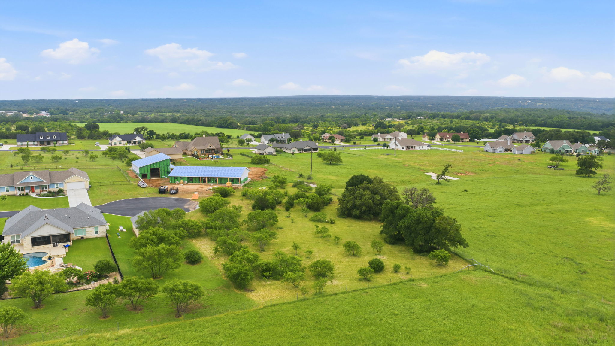 104 Round Up Circle Burnet, TX 78611 - Photo 16 of 23 Expansive green landscape featuring scattered trees and residential properties