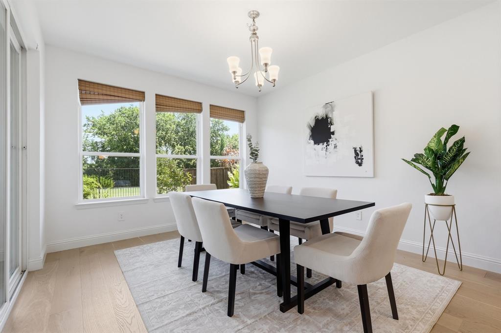 539 Farrell Lane Allen, TX 75013 - Photo 13 of 39 Bright dining area featuring a modern chandelier and large windows with bamboo blinds