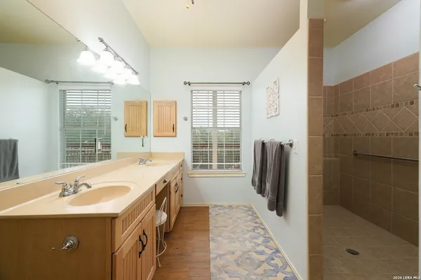 a bathroom with a tub sink and mirror