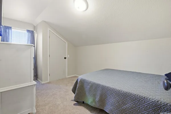 a bedroom with a bed and a cabinets