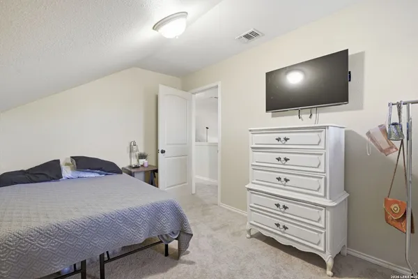 a bedroom with a bed and flat screen tv