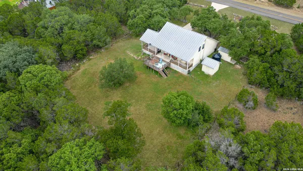 an aerial view of a house with a yard basket ball court and outdoor seating