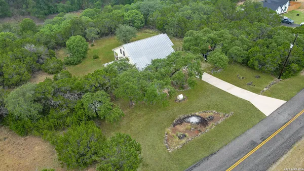 an aerial view of a house with a yard