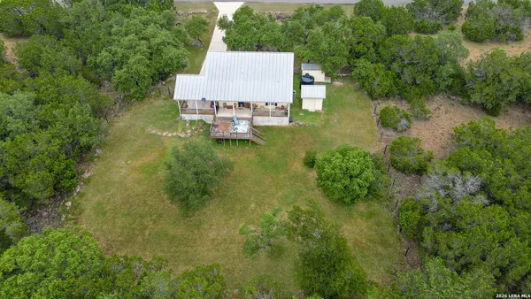 an aerial view of a house with pool outdoor seating and yard
