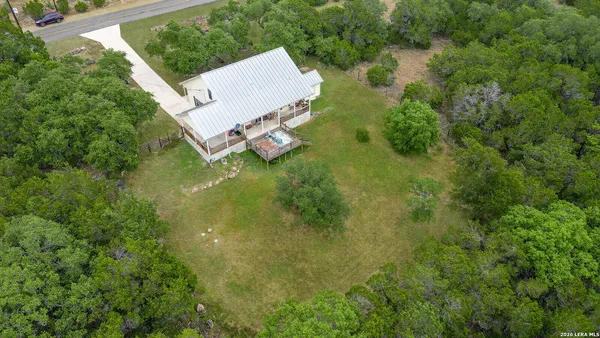 an aerial view of a house with pool big yard and outdoor seating