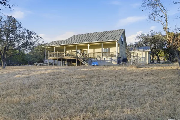 a view of a house with backyard porch and sitting area