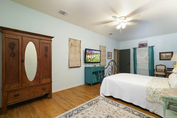a bedroom with a bed and a mirror