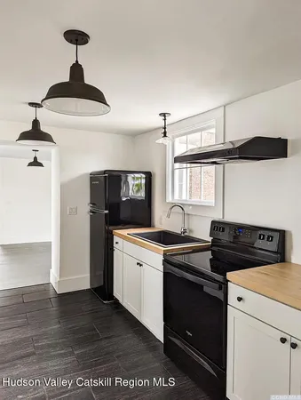 a kitchen with a sink cabinets and window