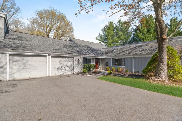 a view of a house with patio and fire pit