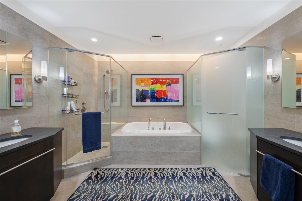 401 North Wabash Avenue, Unit 73F Chicago, IL 60611 - Photo 11 of 40 a bathroom with a sink a large mirror and a shower