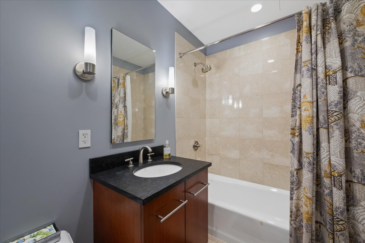 401 North Wabash Avenue, Unit 73F Chicago, IL 60611 - Photo 12 of 40 a bathroom with a granite countertop sink a mirror a shower and a mirror