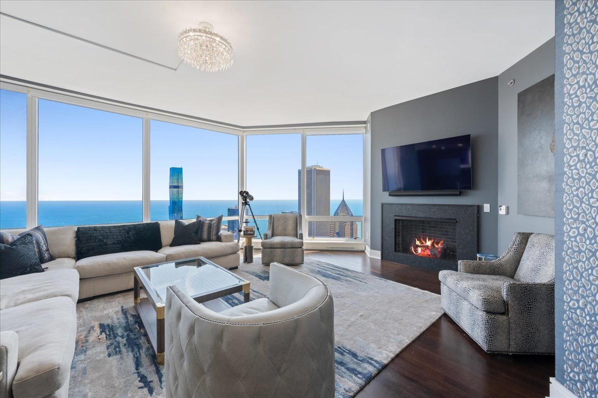 401 North Wabash Avenue, Unit 73F Chicago, IL 60611 - Photo 2 of 40 a living room with furniture and a fireplace