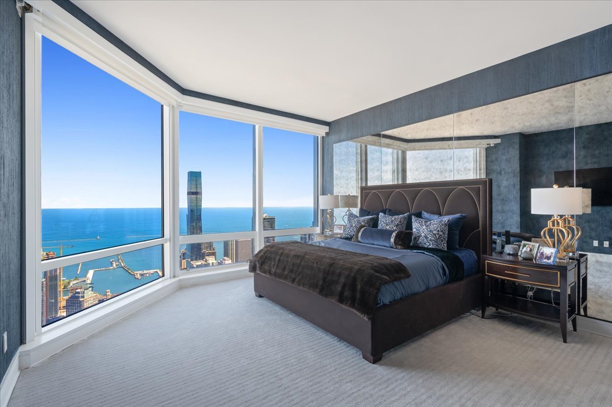 401 North Wabash Avenue, Unit 73F Chicago, IL 60611 - Photo 9 of 40 a spacious bedroom with a bed and a walk in closet