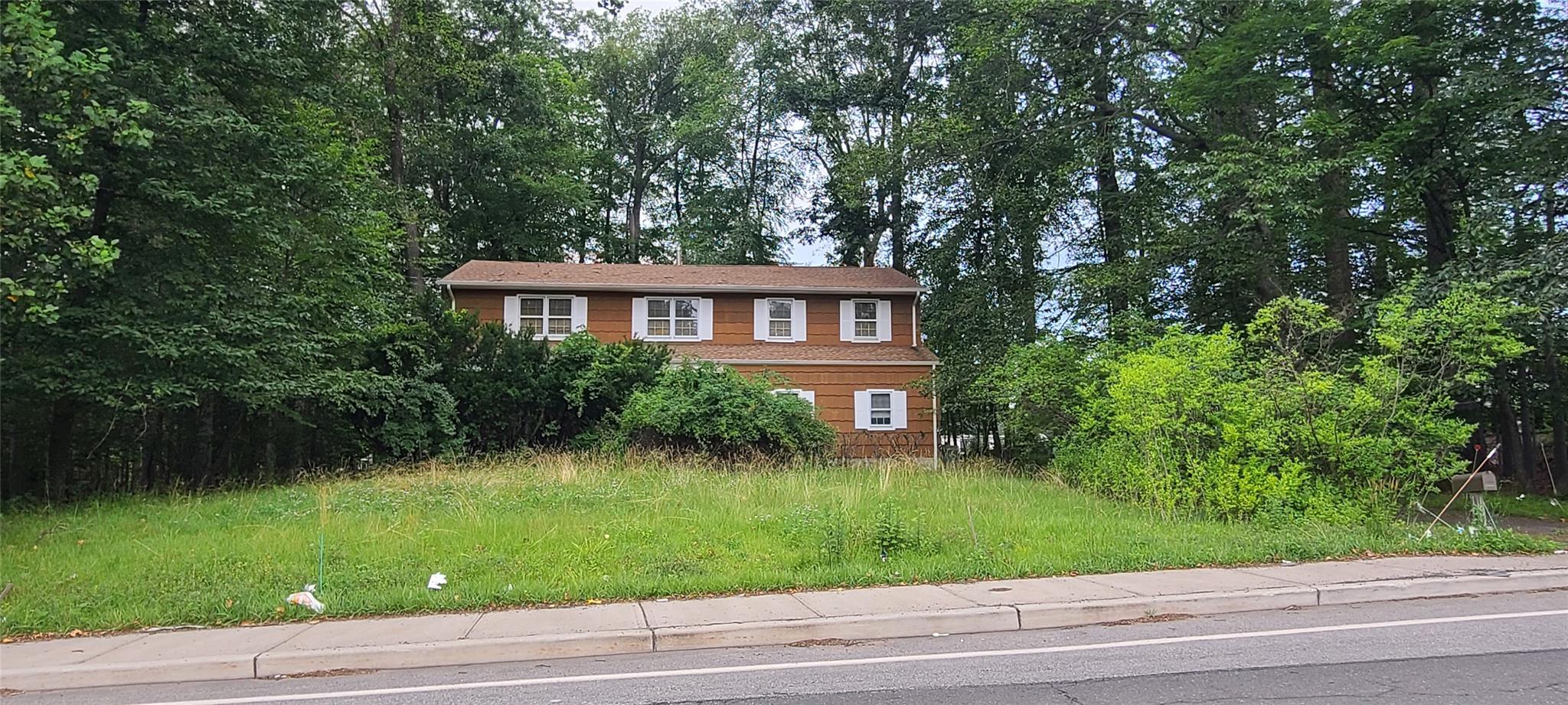 100 Highview Road Suffern, NY 10901 - Photo 1 of 1 a front view of a house with a yard and trees