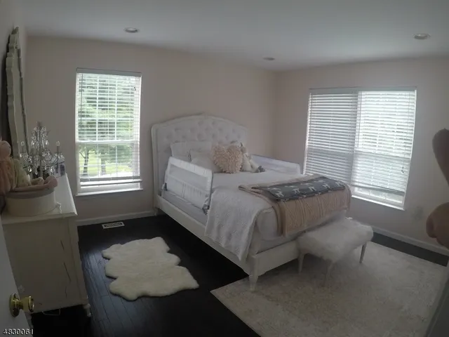 a bedroom with a bed couch and window