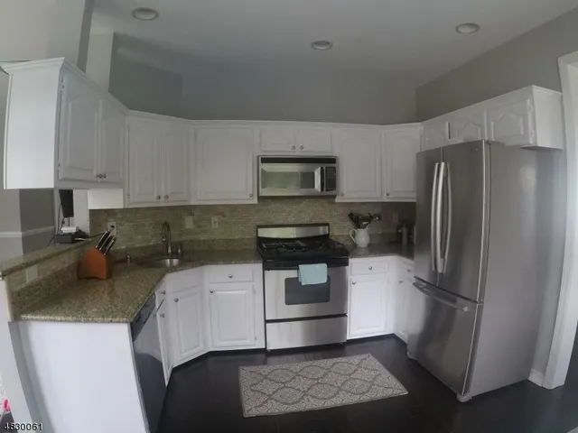 a kitchen with a refrigerator stove and sink