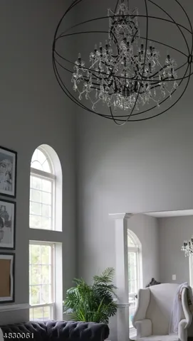 a view of a living room with a window and chandelier